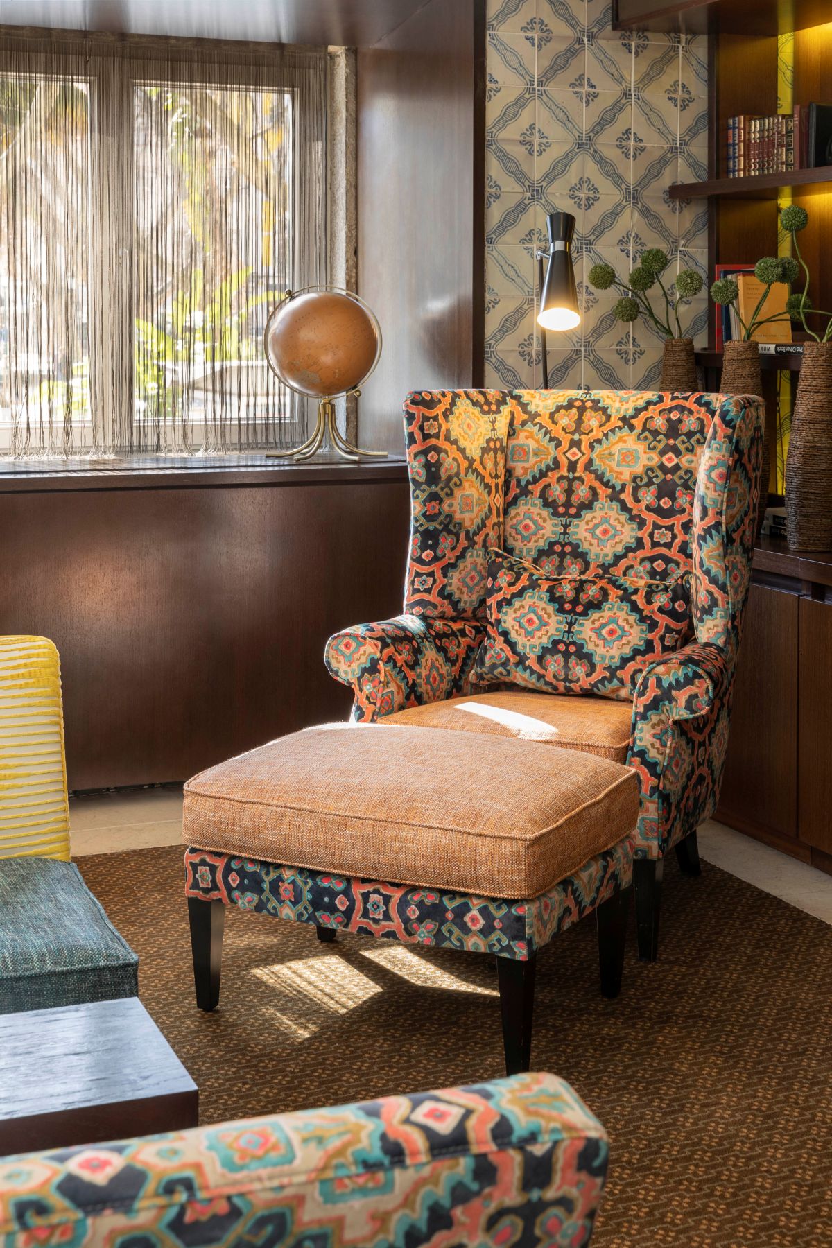 a chair and ottoman in a room