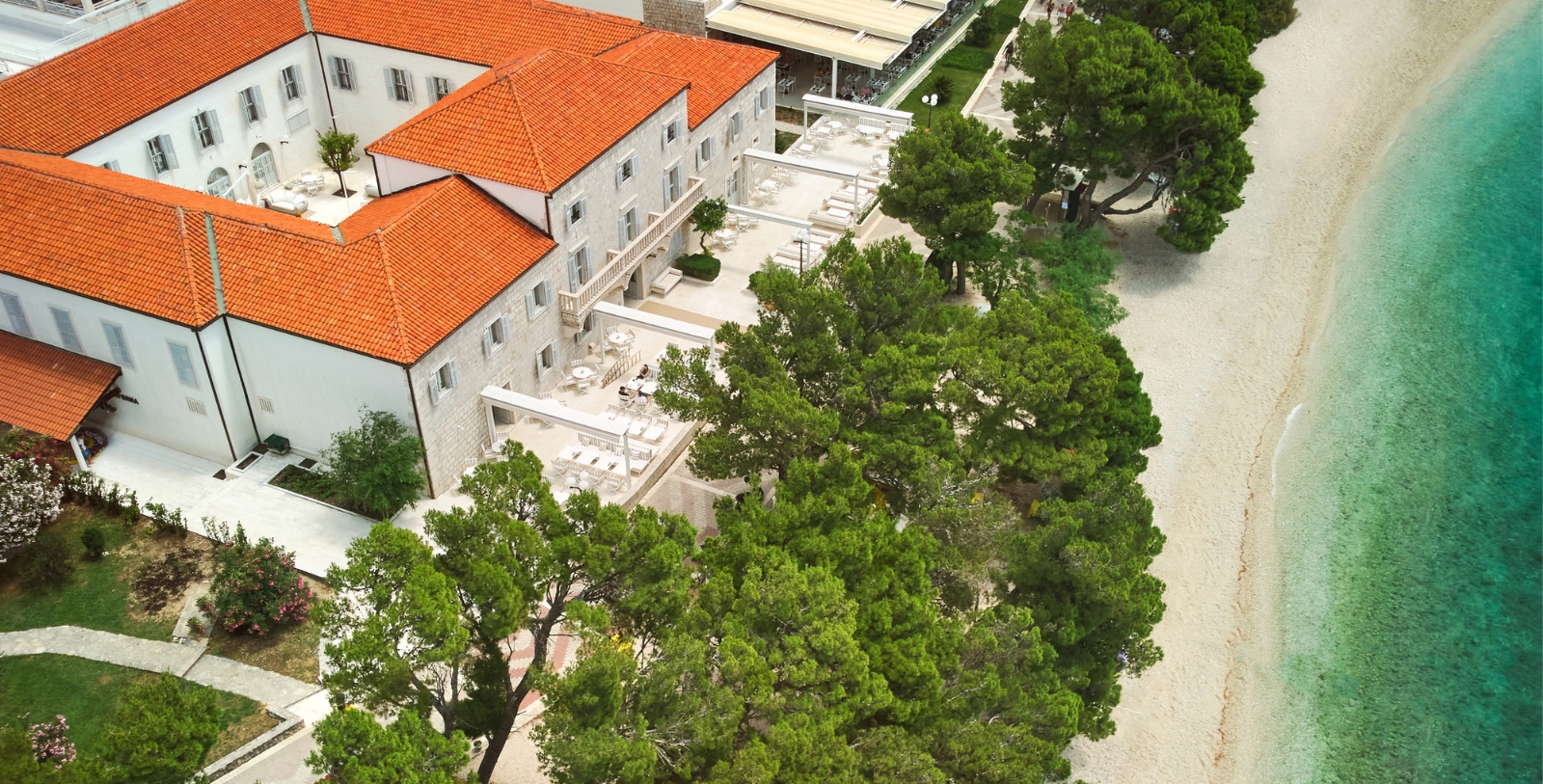 a building with trees and a red roof