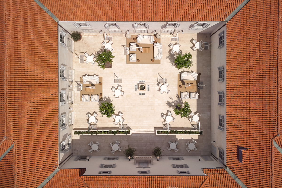 an aerial view of a courtyard with chairs and tables
