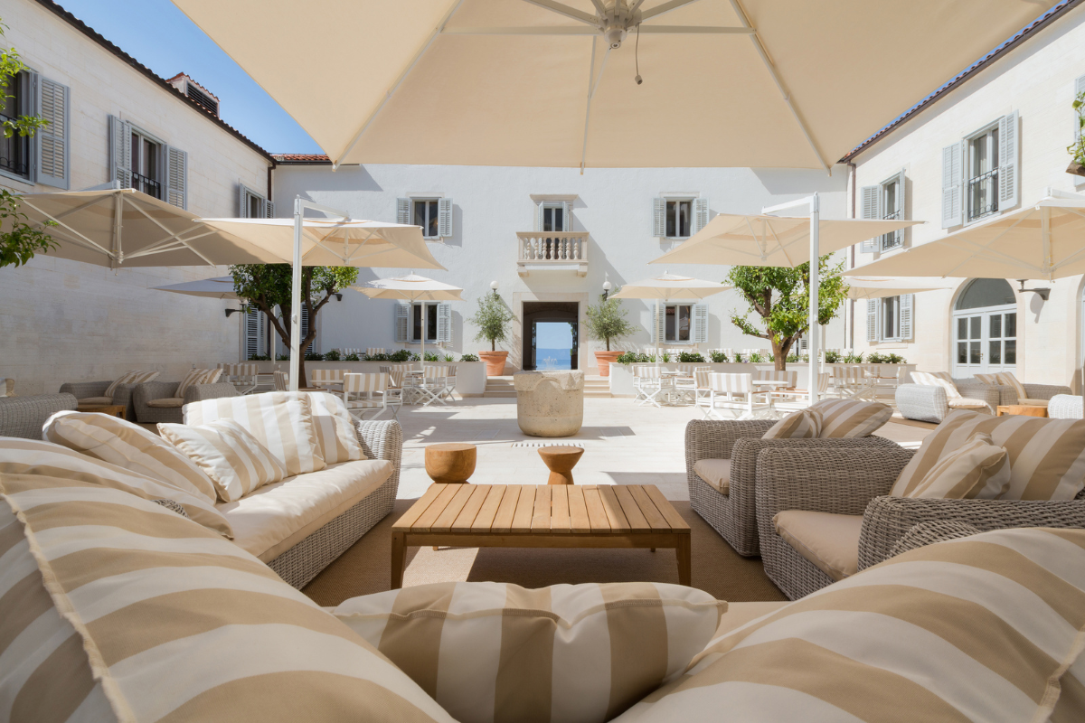 a patio area with a large umbrella and chairs