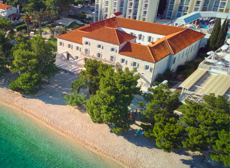 a building with trees and a beach