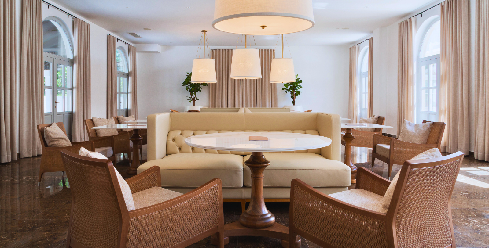 a room with a couch and chairs