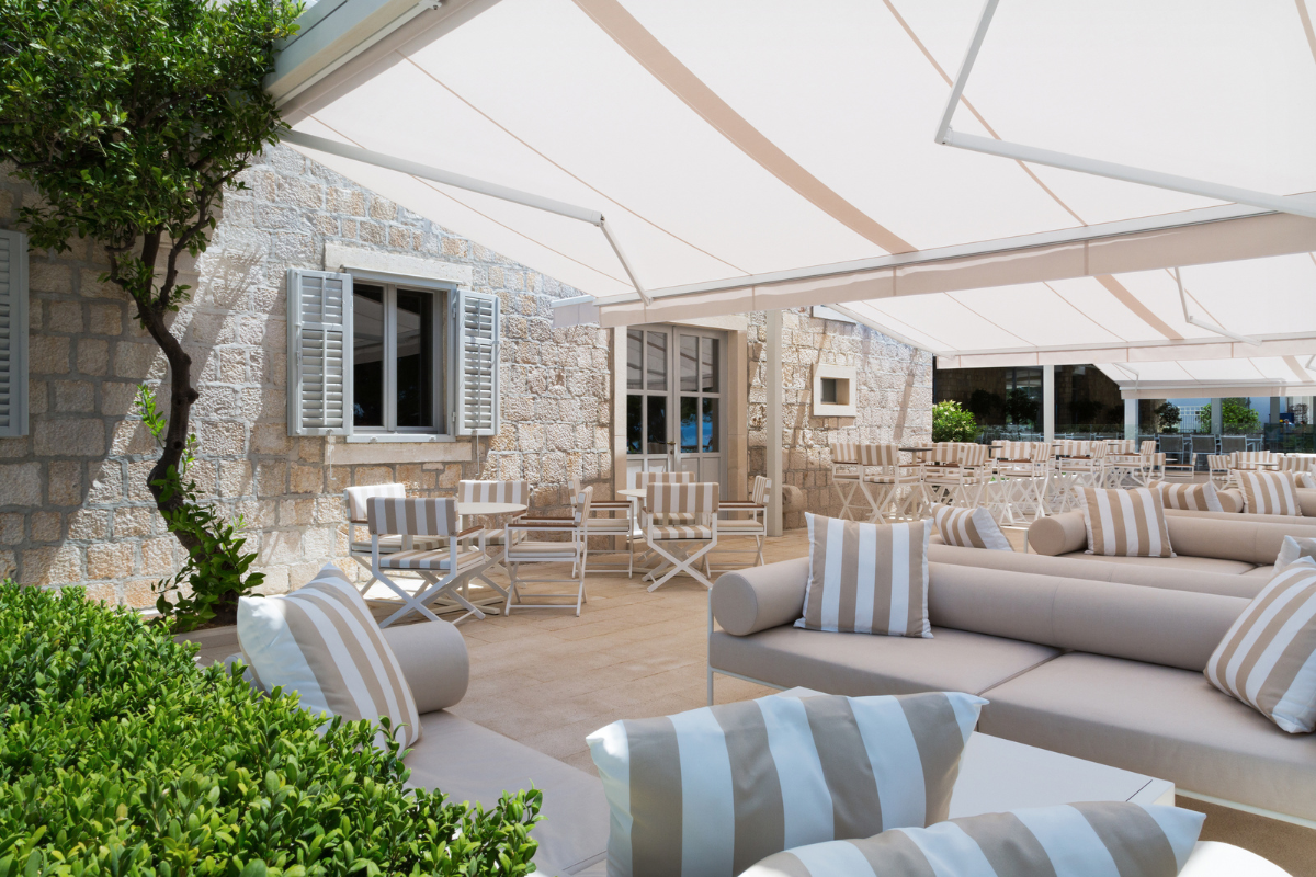 a patio with chairs and tables and chairs