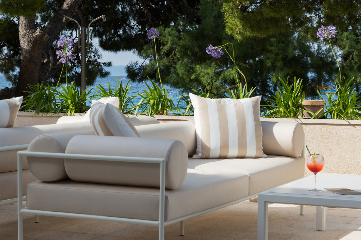 a white couch with pillows on a patio