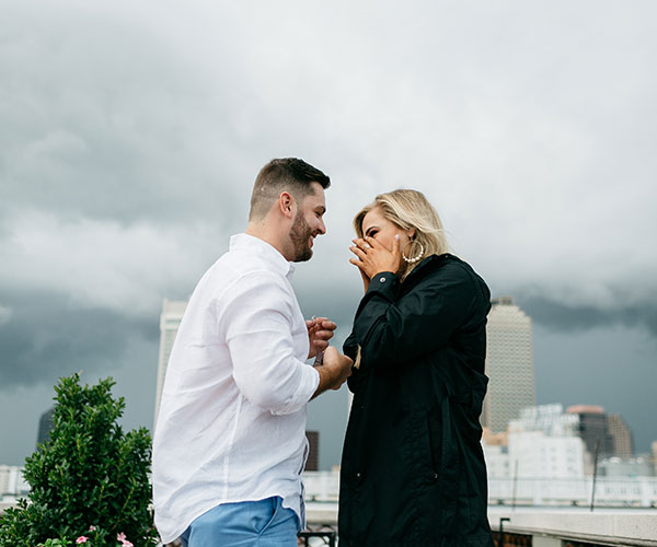a man and woman standing on a rooftop