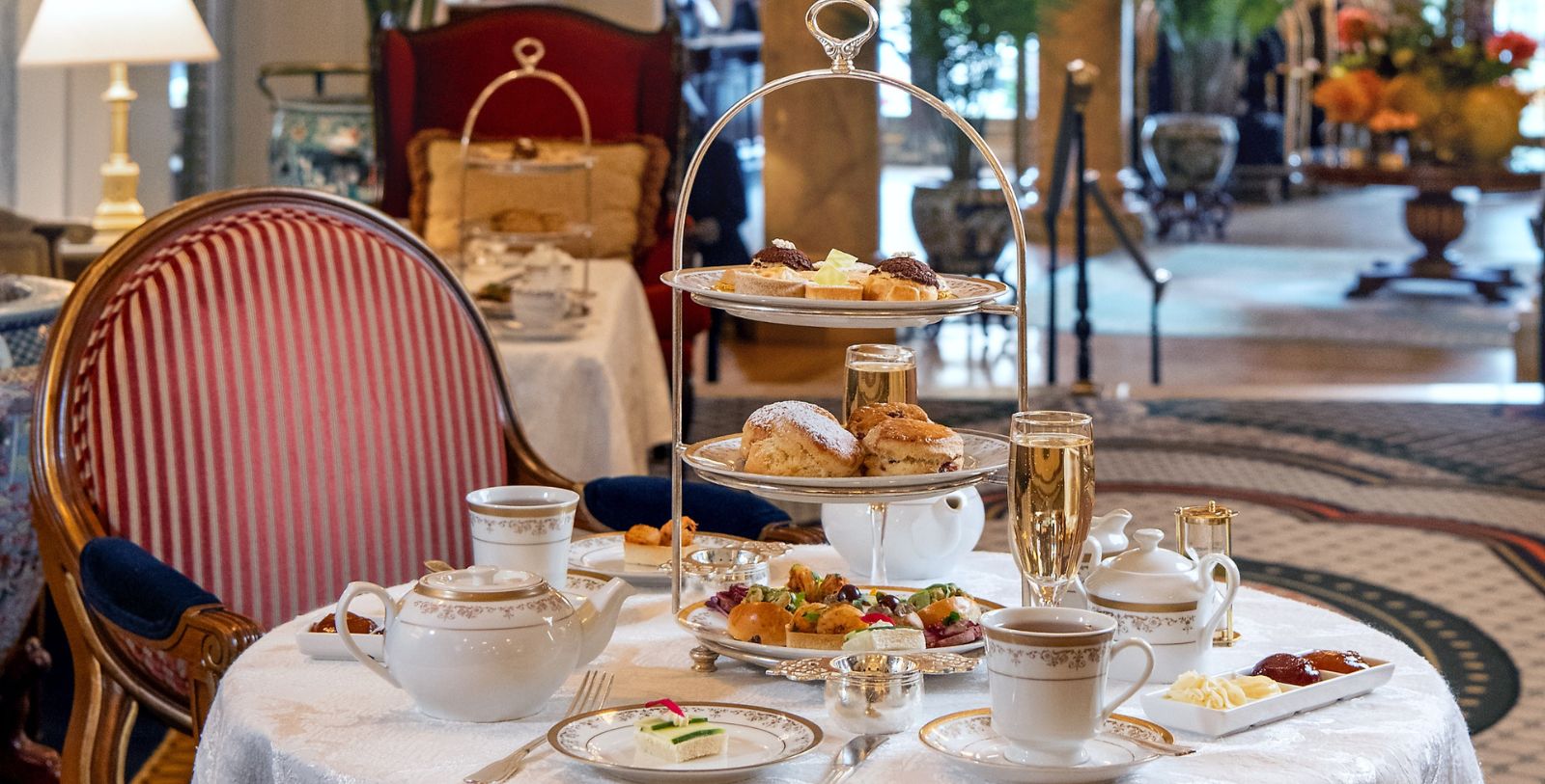 a tea set with a tray of pastries and teapots