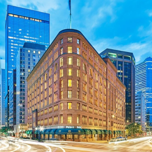 Brown Palace Hotel street with buildings and cars