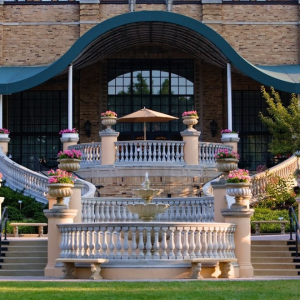 a building with a fountain and a lawn