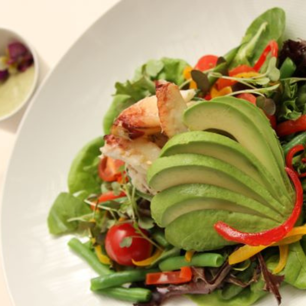 a plate of salad with avocado and vegetables