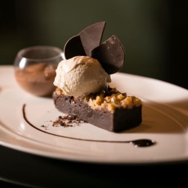 a plate of dessert with a scoop of ice cream on top