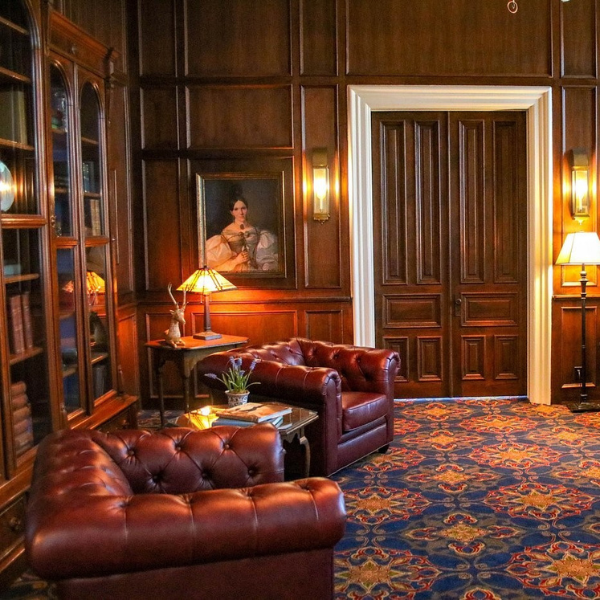 a room with a bookcase and chairs