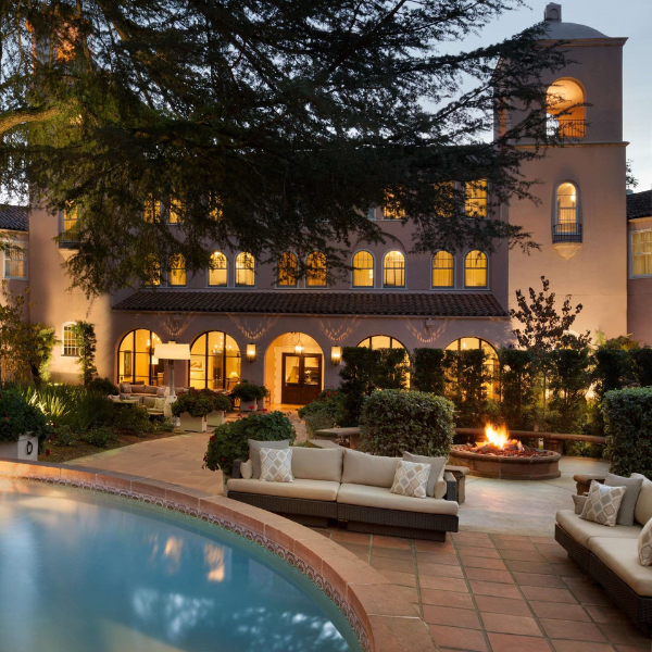 a pool with a large building and a couch