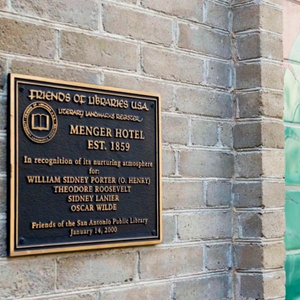 a sign on a brick wall