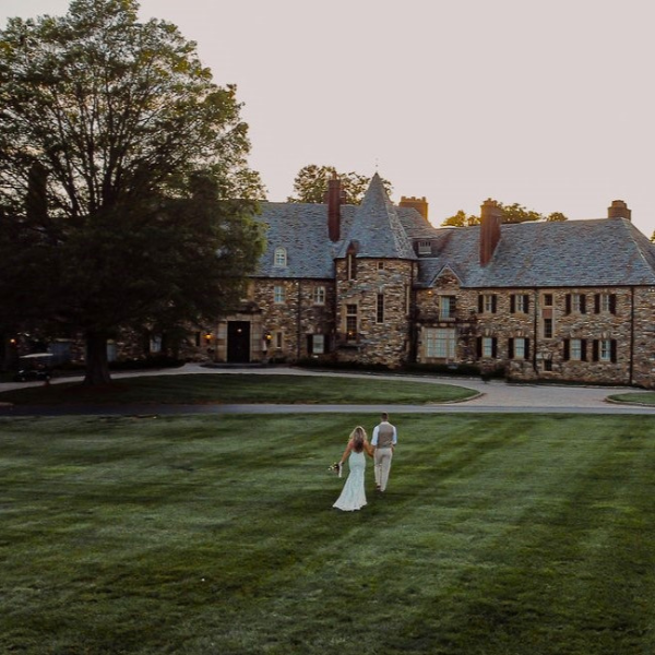 a man and woman walking in a lawn