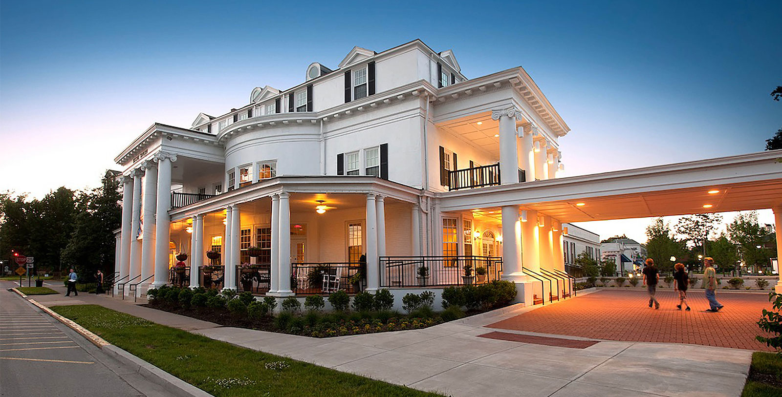 a large white house with columns and a walkway