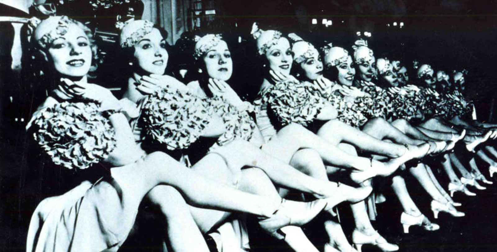 a group of women sitting in a row