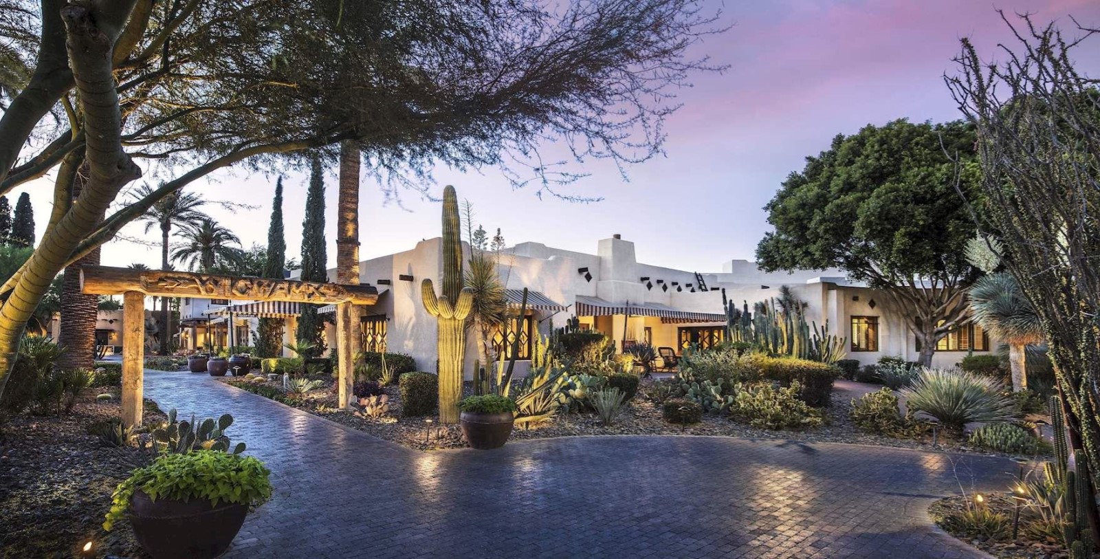 a house with cactus and trees