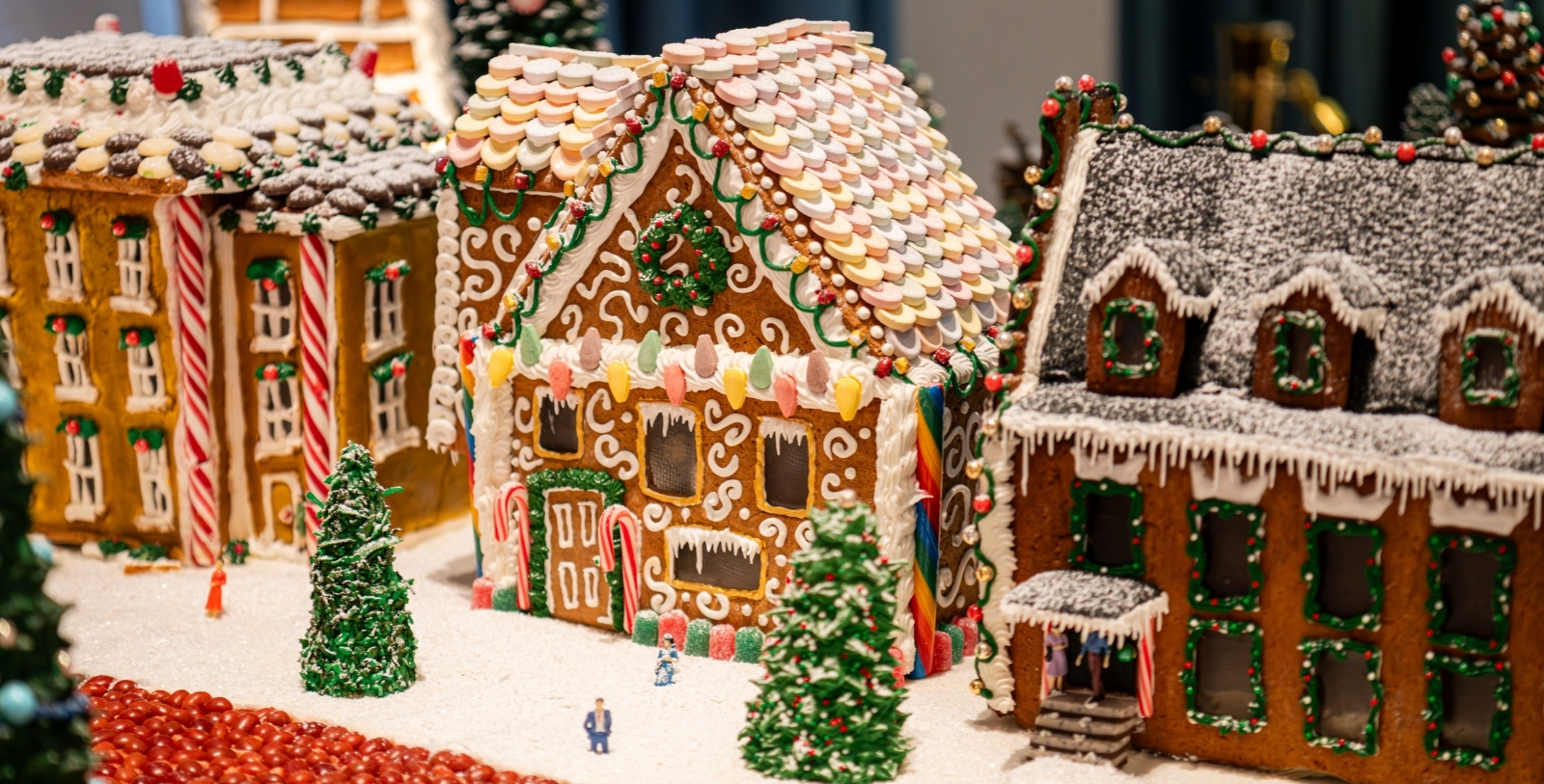 a gingerbread house with a couple of people