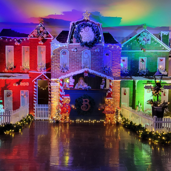 a group of houses with lights and a fence