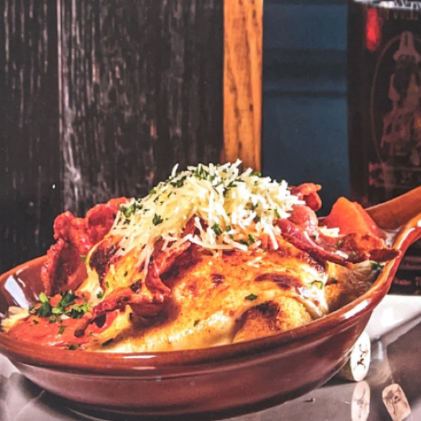 a bowl of food with a wooden handle