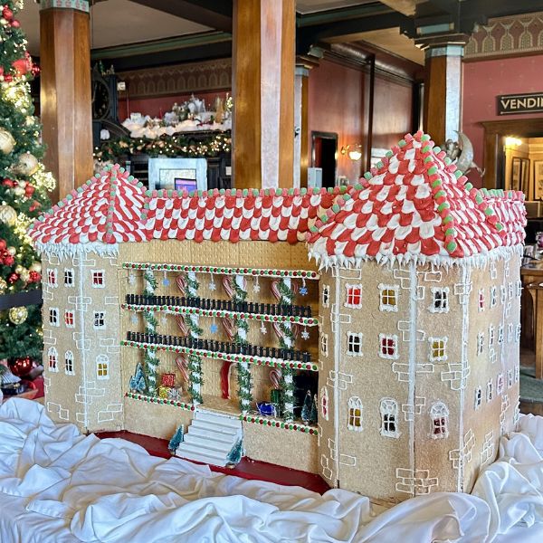 a gingerbread house on a white cloth