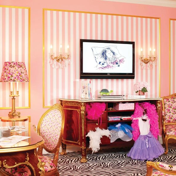 a room with pink and white striped walls
