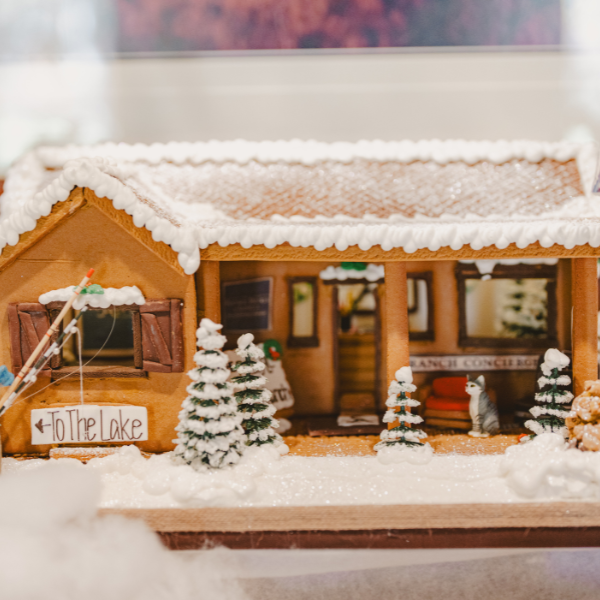 a gingerbread house with snow on it