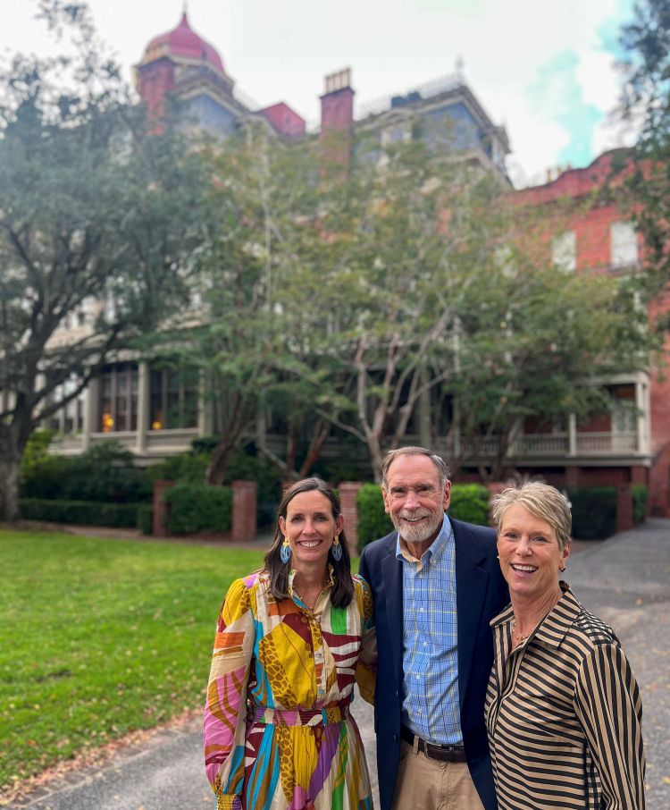 a group of people standing in front of a house