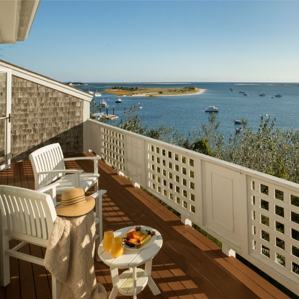 a deck with a table and chairs and a hat on it