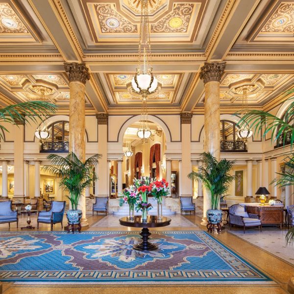 a large lobby with a large rug and chairs