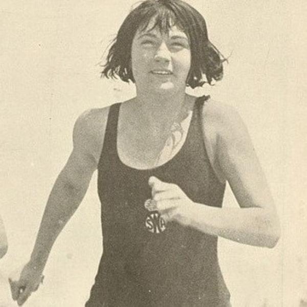 a woman running with a woman in a swimsuit