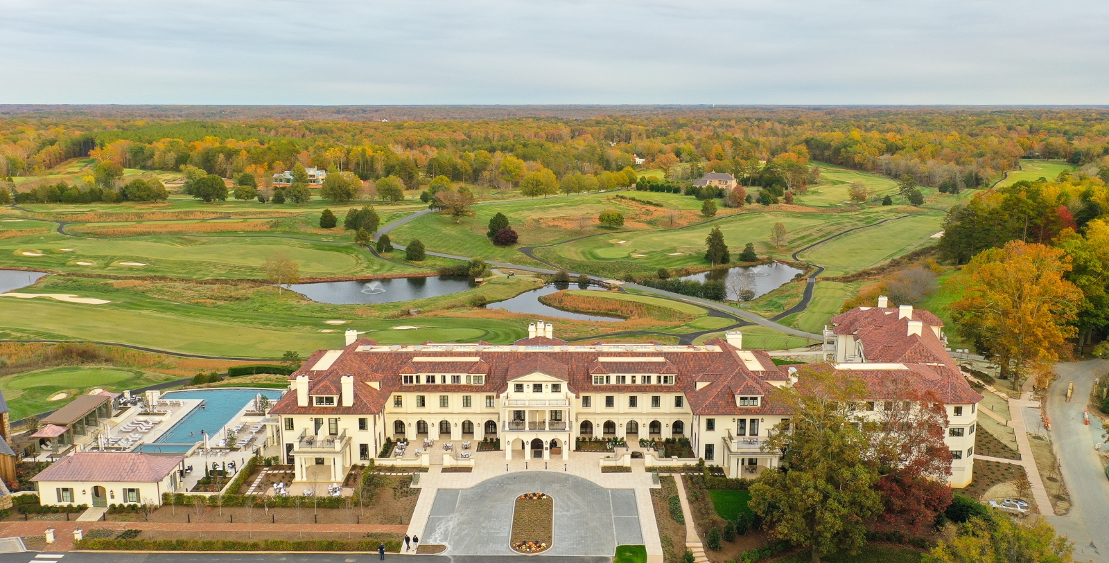 a large building with a pool and a golf course