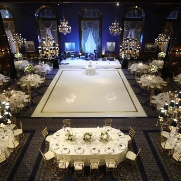 a room with tables and chairs and chandeliers