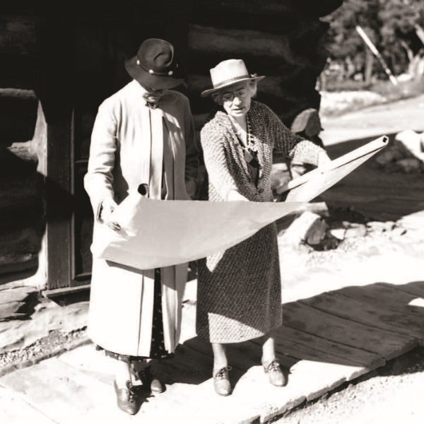 a couple of women looking at a map