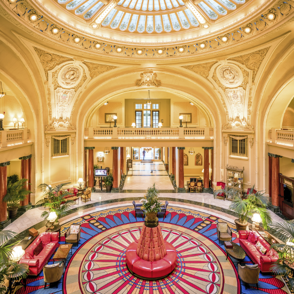 a large circular building with a large round floor and a large red couch