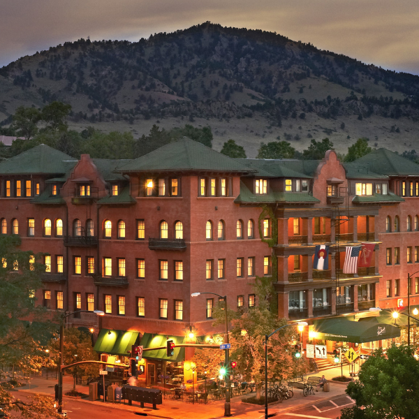 a building with trees and mountains in the background