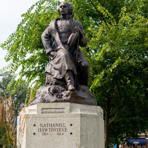 a statue of a man sitting on a stone base