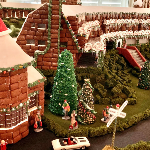 a gingerbread house with trees and people