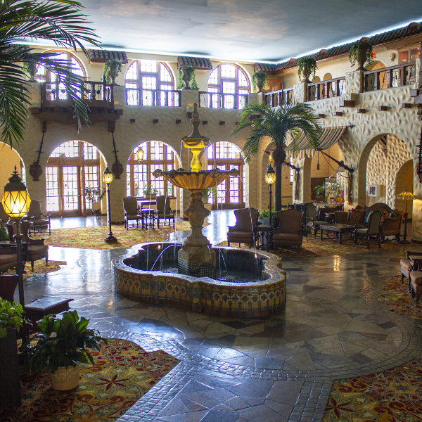 a room with a fountain and chairs
