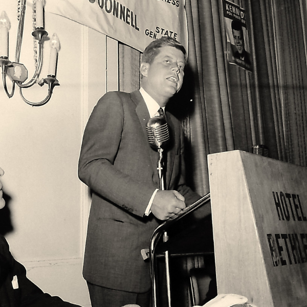 a man standing at a podium with a microphone