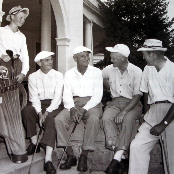 a group of men sitting on a porch
