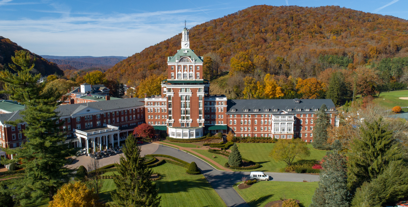 a large building with a tower and a lawn in front of it