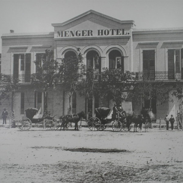 a horse drawn carriage in front of a hotel