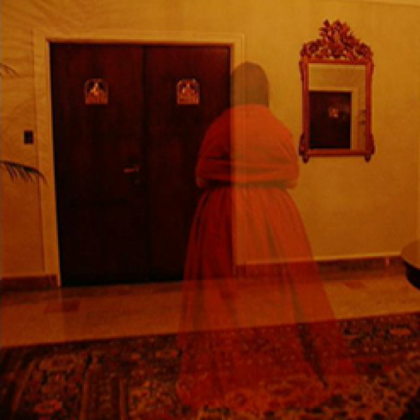 a woman in a red dress standing in front of a door