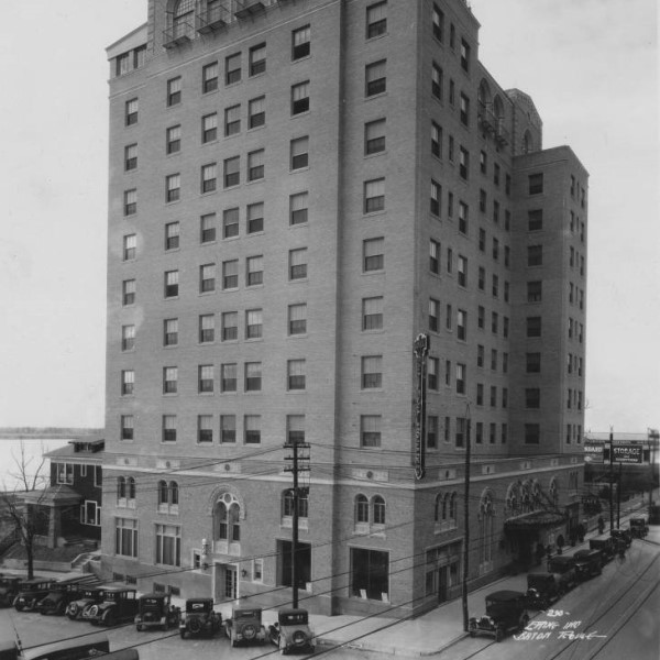 a tall building with cars parked on the side