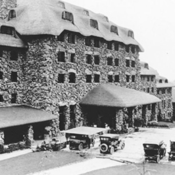 a stone building with many cars parked outside