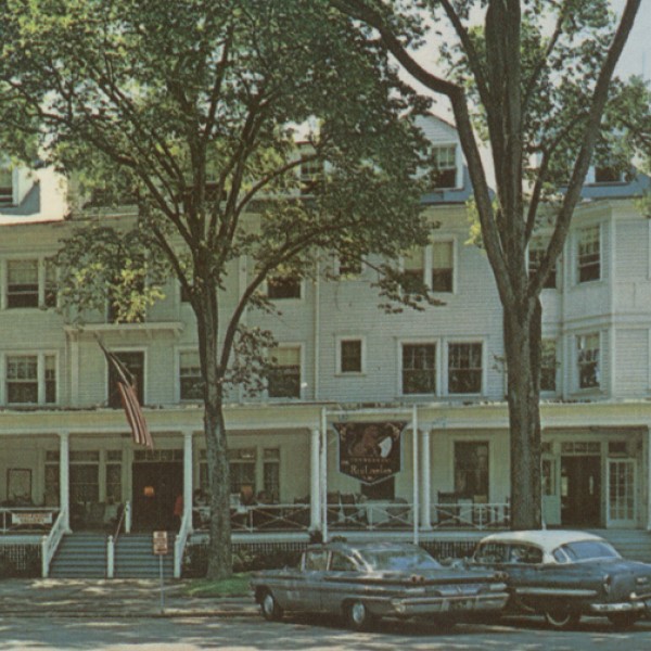 a white building with cars parked in front of it