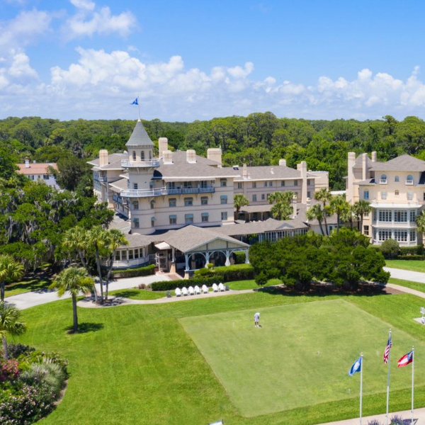 a large building with a lawn and trees