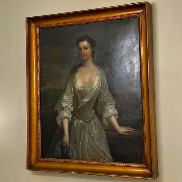 a painting of a woman in a gold frame