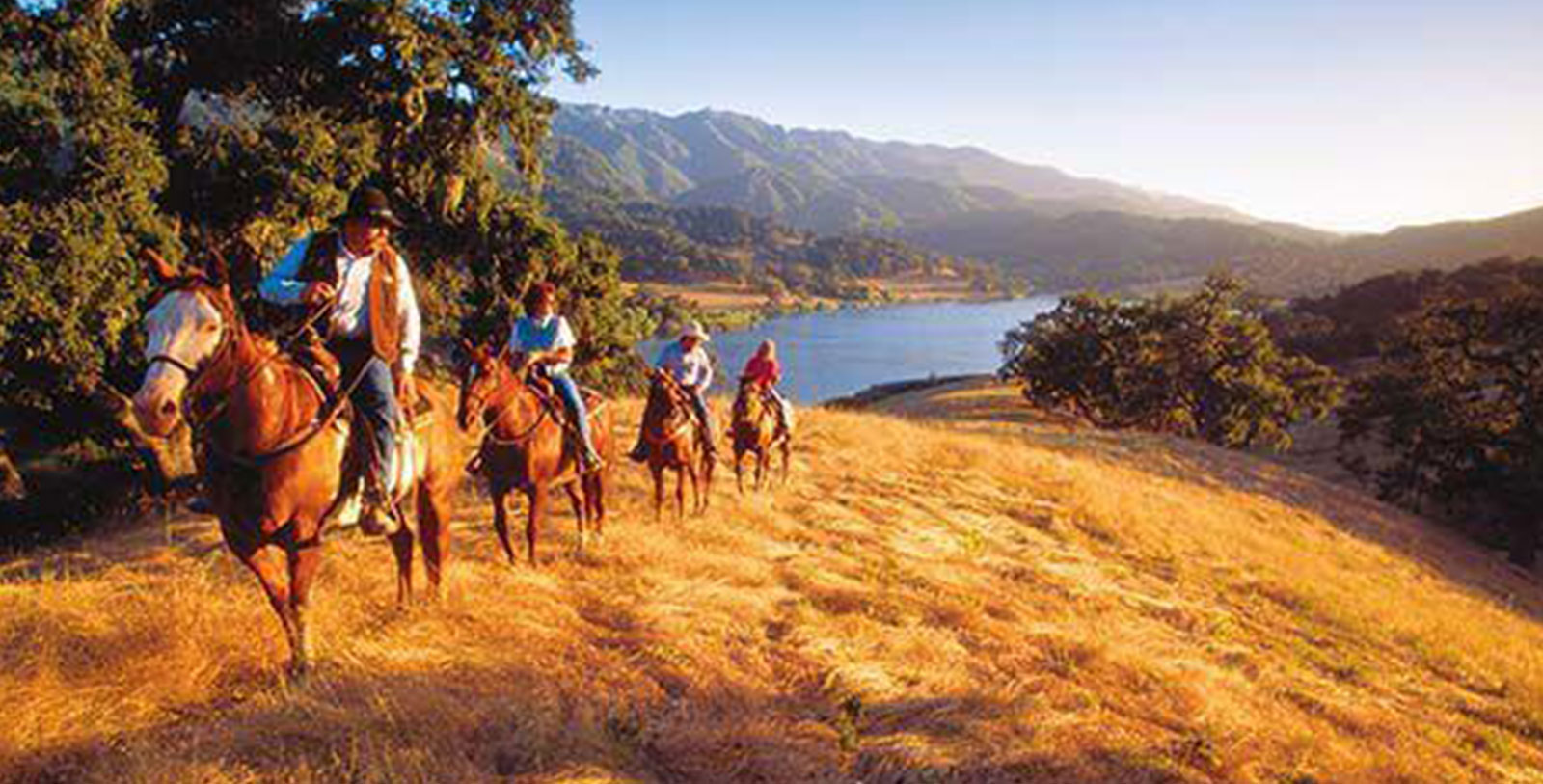 a group of people riding horses